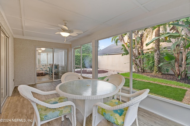 sunroom / solarium featuring ceiling fan