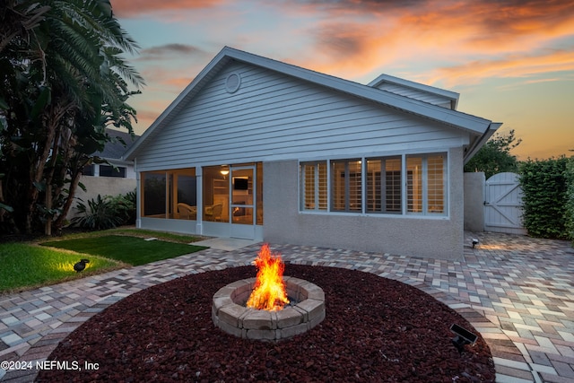 back house at dusk with a fire pit