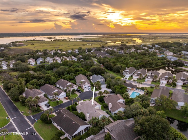 aerial view at dusk with a water view