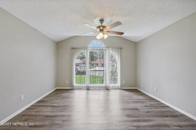 unfurnished room with ceiling fan, lofted ceiling, a textured ceiling, and dark hardwood / wood-style flooring