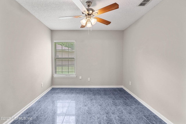 empty room with ceiling fan and a textured ceiling