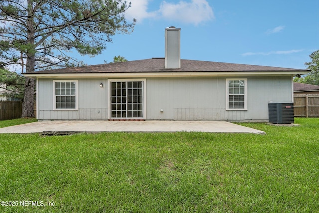 rear view of property with a patio, a yard, and central air condition unit