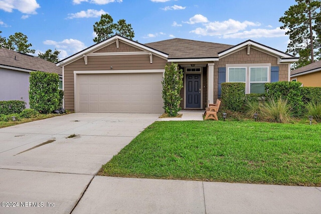 view of front of property with a garage and a front yard