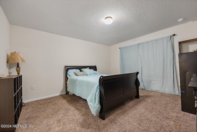 carpeted bedroom with a textured ceiling