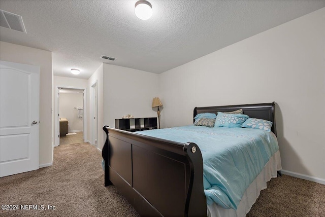 carpeted bedroom with a textured ceiling