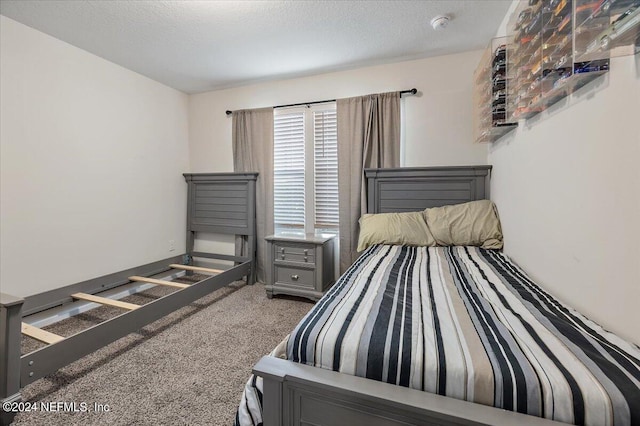 bedroom with a textured ceiling and carpet