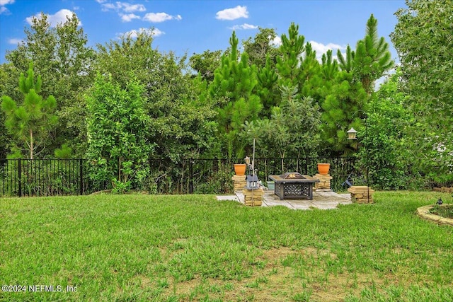 view of yard with an outdoor fire pit and a patio