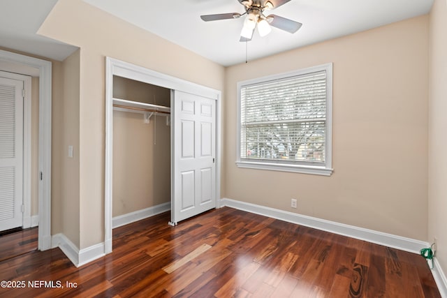 unfurnished bedroom featuring ceiling fan, dark hardwood / wood-style floors, and a closet