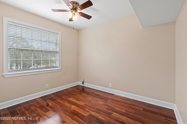 empty room featuring ceiling fan and dark hardwood / wood-style flooring