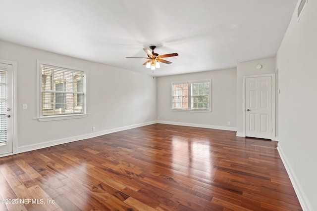 unfurnished room with ceiling fan and dark hardwood / wood-style flooring