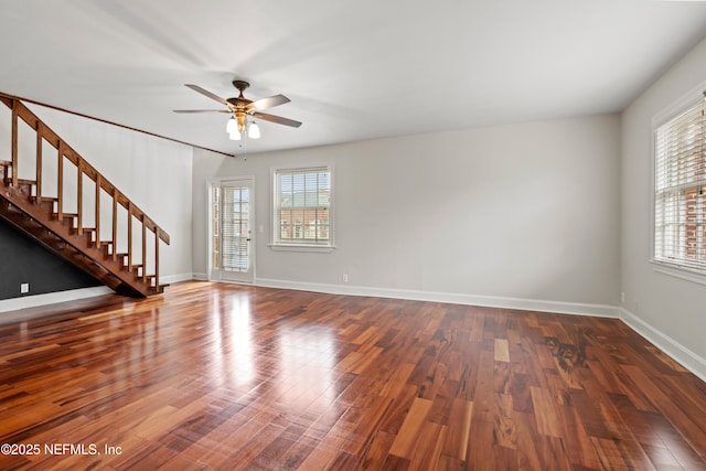 unfurnished living room with dark hardwood / wood-style floors and ceiling fan