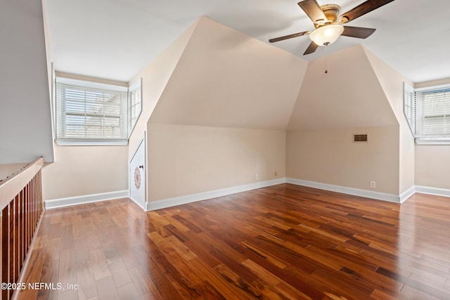 additional living space featuring hardwood / wood-style flooring, ceiling fan, and lofted ceiling