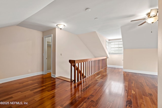 additional living space featuring lofted ceiling, dark hardwood / wood-style floors, and ceiling fan