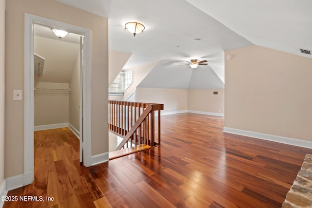 additional living space featuring dark wood-type flooring, ceiling fan, and lofted ceiling