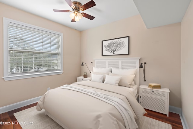 bedroom featuring ceiling fan and dark hardwood / wood-style floors