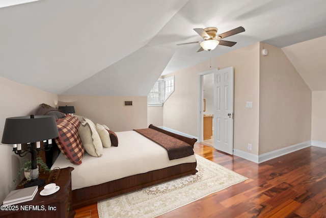 bedroom with hardwood / wood-style floors, vaulted ceiling, and ceiling fan