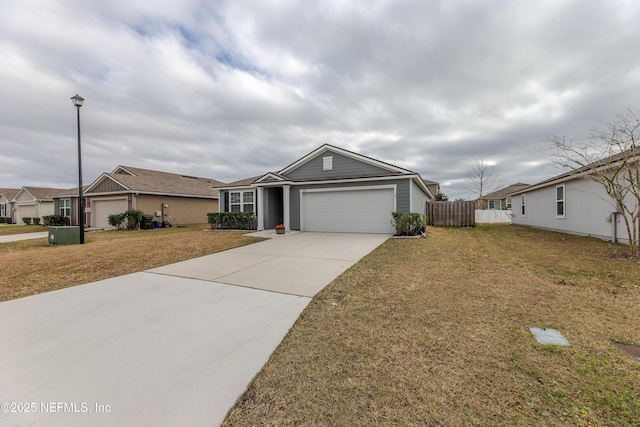 ranch-style home featuring an attached garage, fence, driveway, a residential view, and a front lawn