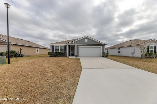 single story home featuring driveway, an attached garage, and a front yard