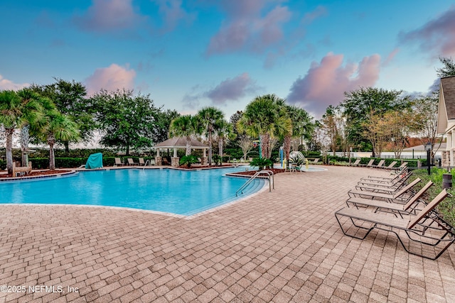 community pool with a patio and a gazebo