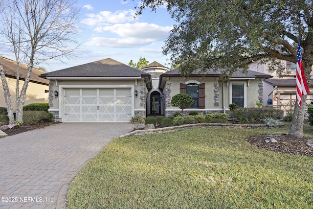 view of front of home with a garage and a lawn