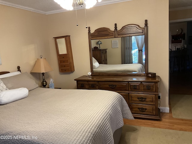 bedroom with crown molding and wood-type flooring