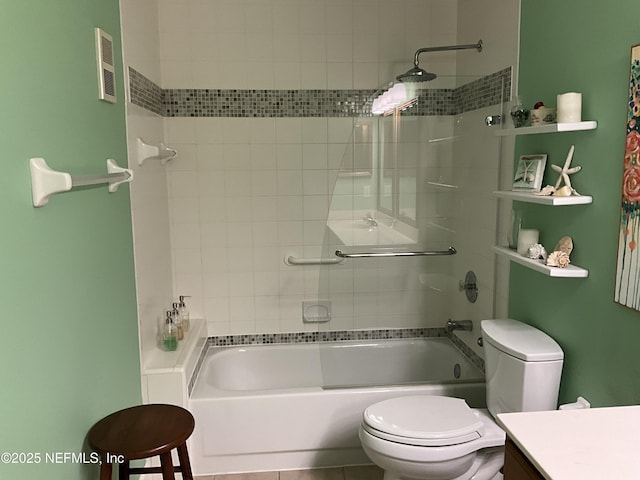 full bathroom with vanity, tiled shower / bath, and toilet