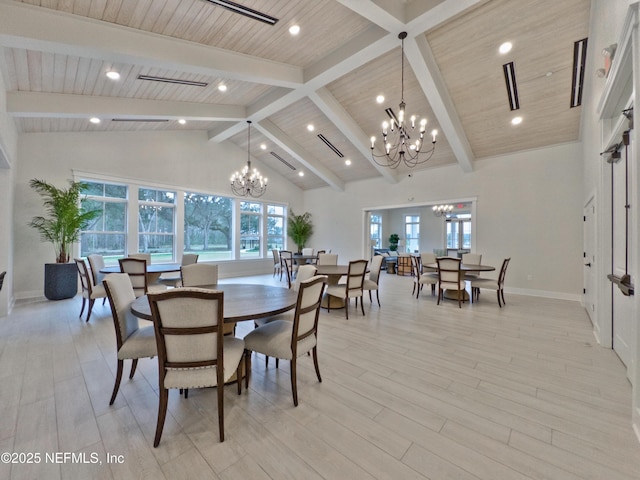 dining space with a chandelier, light wood-style flooring, and high vaulted ceiling