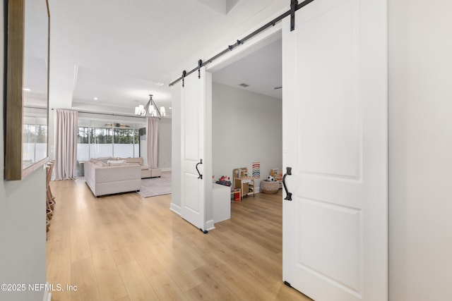 interior space featuring a barn door and light wood-style flooring