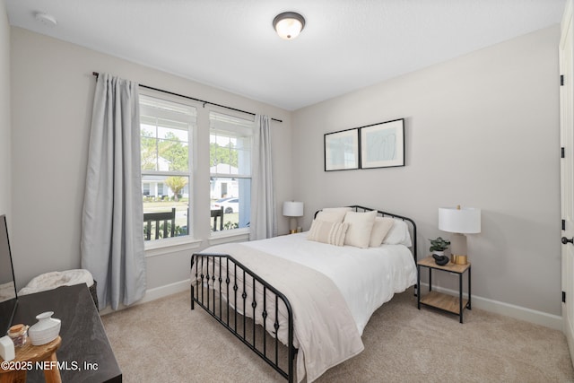 bedroom featuring carpet floors and baseboards