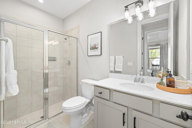 bathroom featuring toilet, a shower stall, tile patterned flooring, and vanity