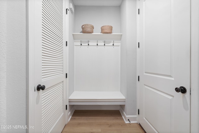 mudroom with light wood-style floors and baseboards