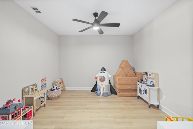 playroom featuring visible vents, wood finished floors, a ceiling fan, and baseboards