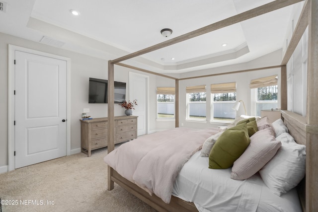 bedroom featuring ornamental molding, a raised ceiling, visible vents, and light colored carpet