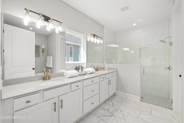 full bath with marble finish floor, a shower stall, visible vents, and a sink