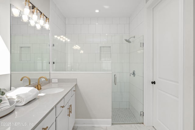 full bath with marble finish floor, vanity, baseboards, and a stall shower