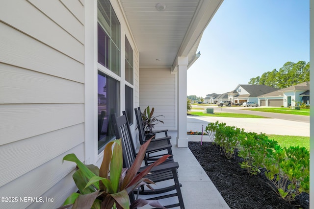 view of patio / terrace with a porch and a residential view