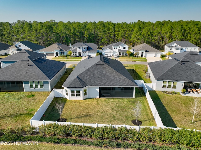 birds eye view of property featuring a residential view and a view of trees