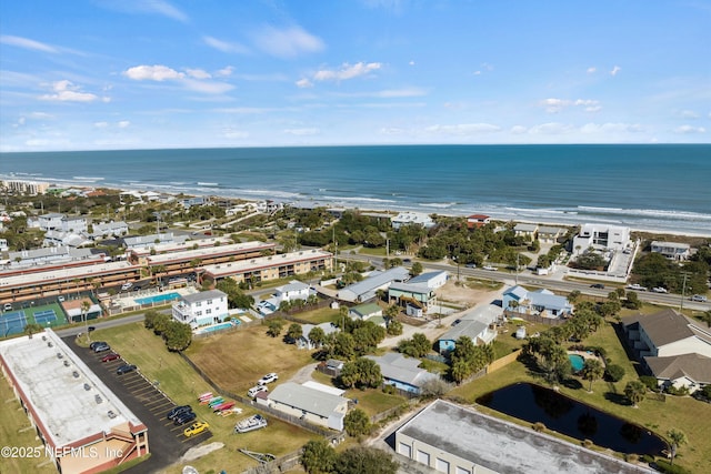 drone / aerial view featuring a water view and a view of the beach