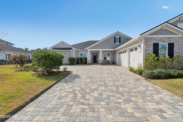 view of front of house with a garage and a front lawn