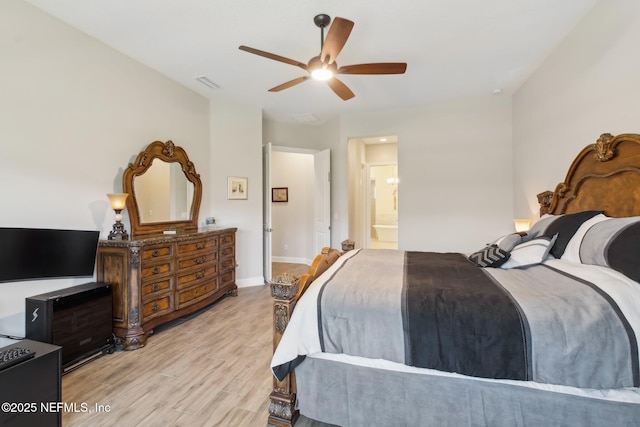 bedroom with ceiling fan, connected bathroom, and light hardwood / wood-style floors