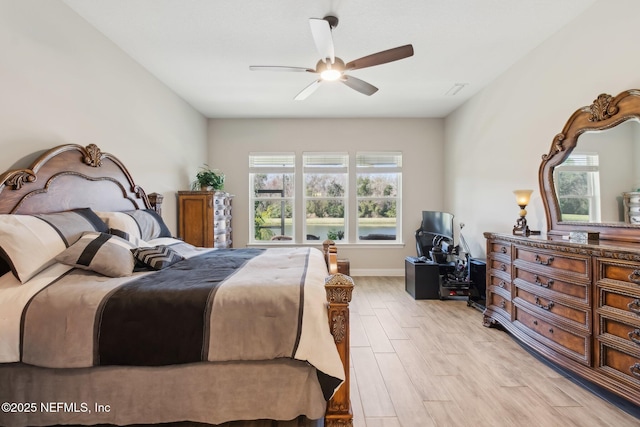 bedroom with ceiling fan and light hardwood / wood-style flooring