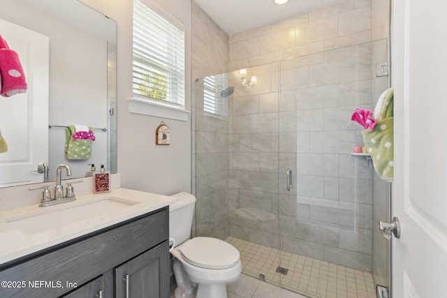 bathroom featuring vanity, toilet, and an enclosed shower