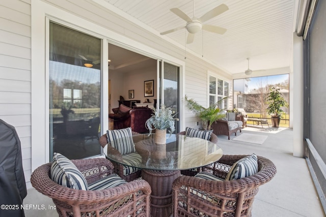 sunroom / solarium featuring ceiling fan