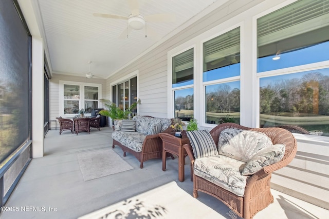 sunroom featuring ceiling fan