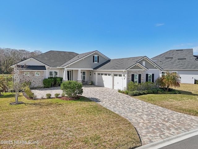 view of front of property featuring a garage and a front lawn