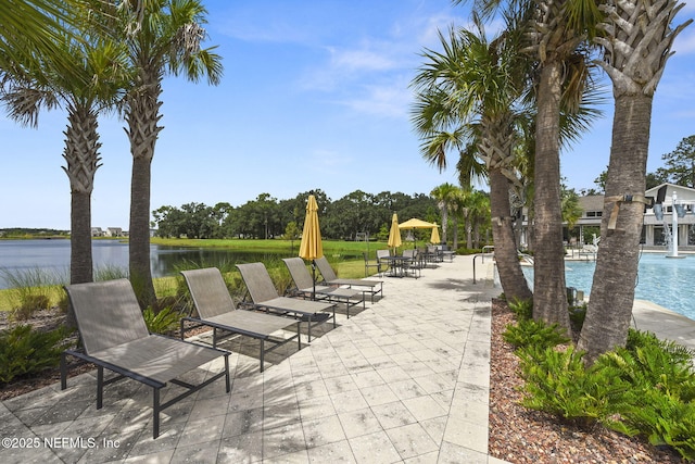 view of patio / terrace with a water view and a community pool