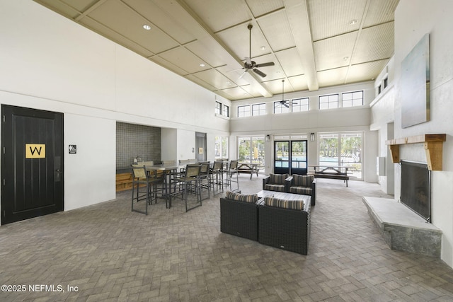 interior space featuring a towering ceiling and ceiling fan