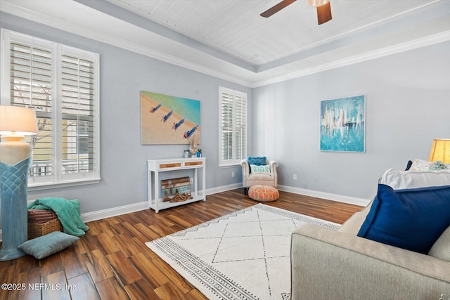 living area with plenty of natural light, dark hardwood / wood-style floors, and ceiling fan