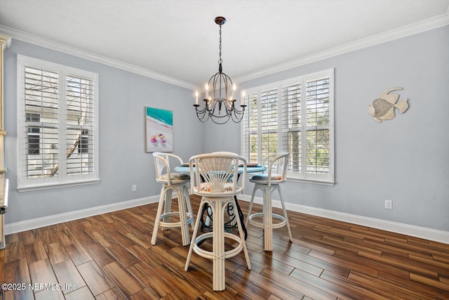 dining area featuring crown molding, dark hardwood / wood-style floors, and a notable chandelier