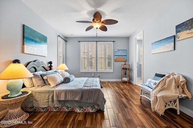 bedroom with ceiling fan, a textured ceiling, and dark hardwood / wood-style flooring